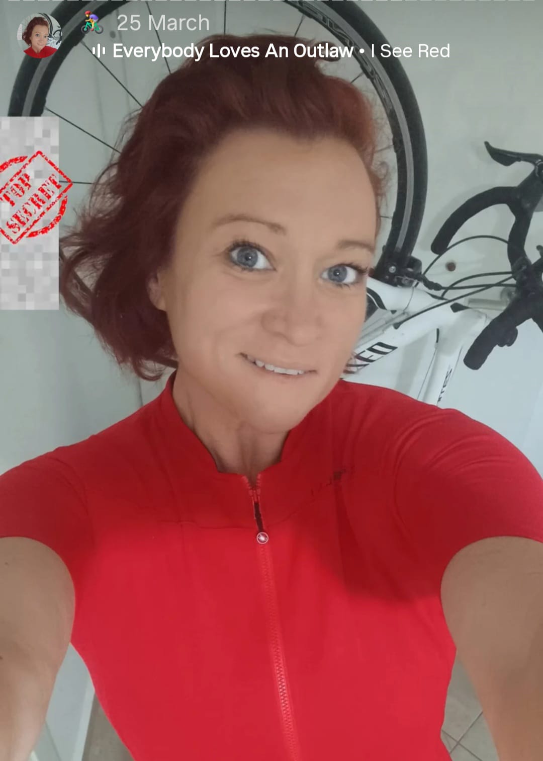 Selfie of Christa from Riding Solo Turkey with her first bike stored in the Placed vertical upright bike system. Wearing a red castelli cycling jersey